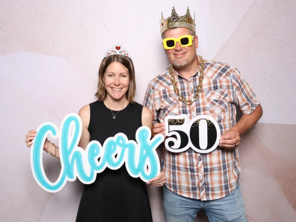 Guests posing with props and backdrop | CaptureME Photo Booth Rental Company in Windsor, CO | Weddings and Corporate Events in Northern Colorado