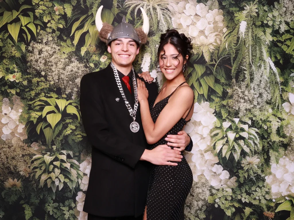Guests posing with props and backdrop | CaptureME Photo Booth Rental Company in Windsor, CO | Weddings and Corporate Events in Northern Colorado