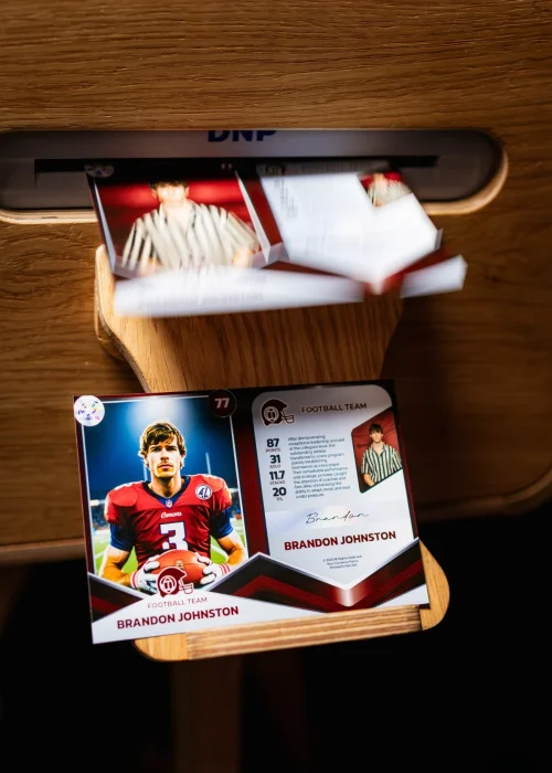 Guest holding a custom printed trading card from a Trading Card Photo Booth