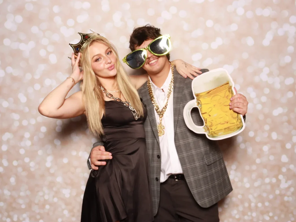 Guests posing with props and backdrop | CaptureME Photo Booth Rental Company in Windsor, CO | Weddings and Corporate Events in Northern Colorado