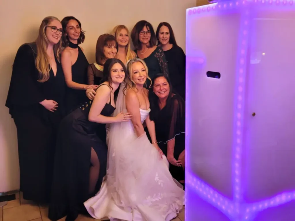 Bride and guests taking black and white glam photo booth portrait at Della Terra wedding in Estes Park Colorado